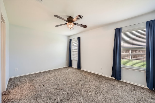 carpeted empty room with baseboards and ceiling fan