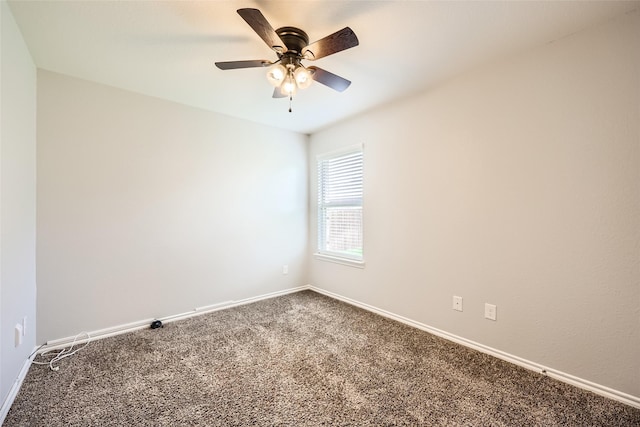 carpeted empty room featuring baseboards and ceiling fan