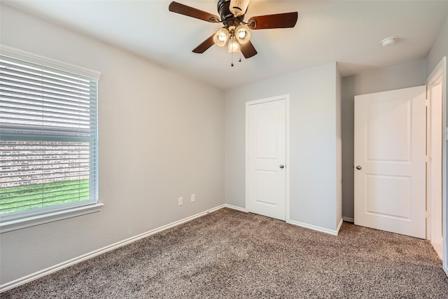 unfurnished bedroom featuring carpet flooring, baseboards, and ceiling fan
