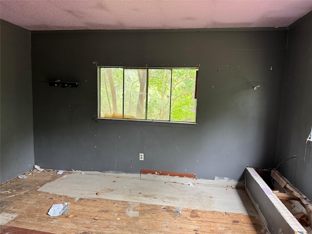 unfurnished room with a textured ceiling
