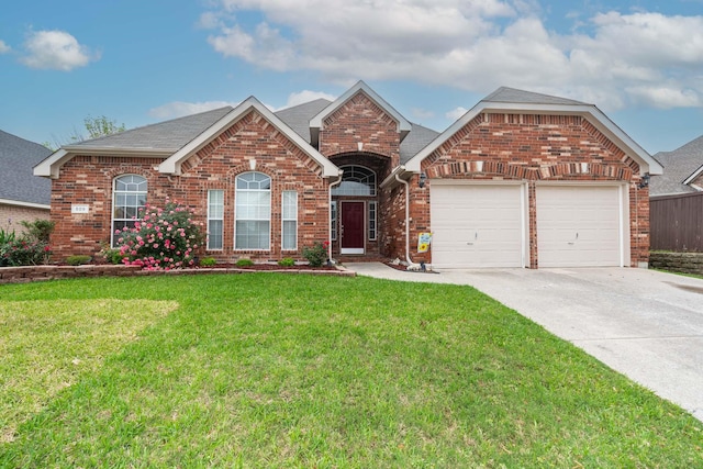 view of front of property with concrete driveway, brick siding, a front yard, and a garage