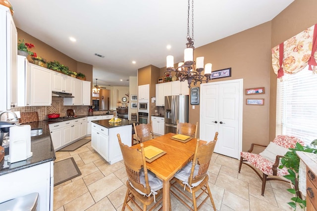 dining space featuring recessed lighting, ceiling fan with notable chandelier, and visible vents