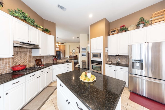 kitchen featuring decorative backsplash, a ceiling fan, visible vents, appliances with stainless steel finishes, and under cabinet range hood