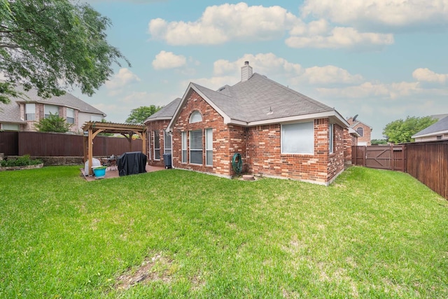 back of property with a pergola, brick siding, a fenced backyard, a patio area, and a yard