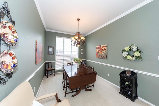 dining room with carpet floors, ornamental molding, and a notable chandelier