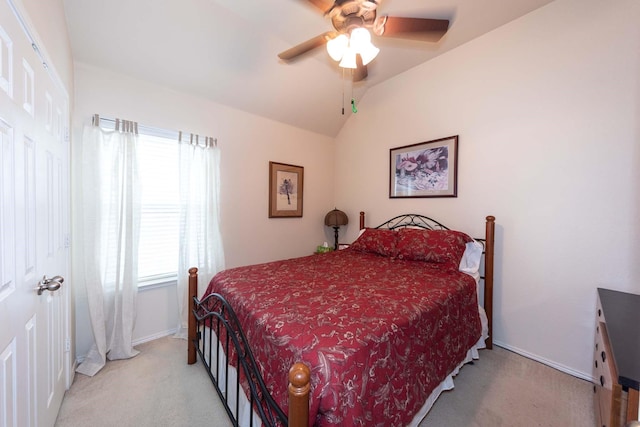 carpeted bedroom featuring baseboards, ceiling fan, and lofted ceiling