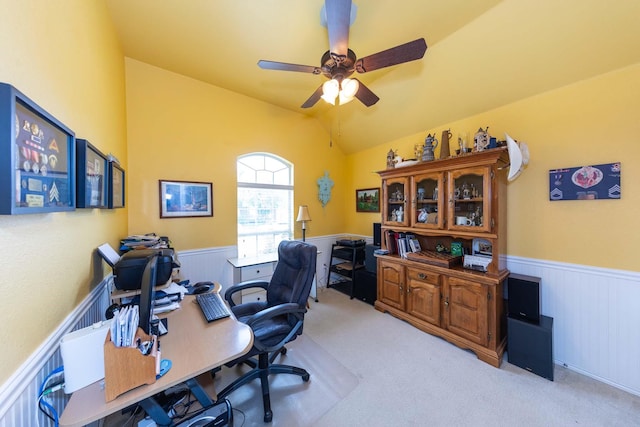 home office with light colored carpet, wainscoting, ceiling fan, and lofted ceiling