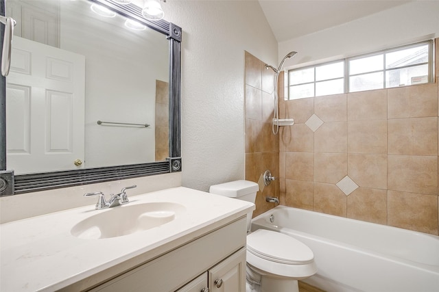 full bath with vaulted ceiling, shower / tub combination, vanity, toilet, and a textured wall