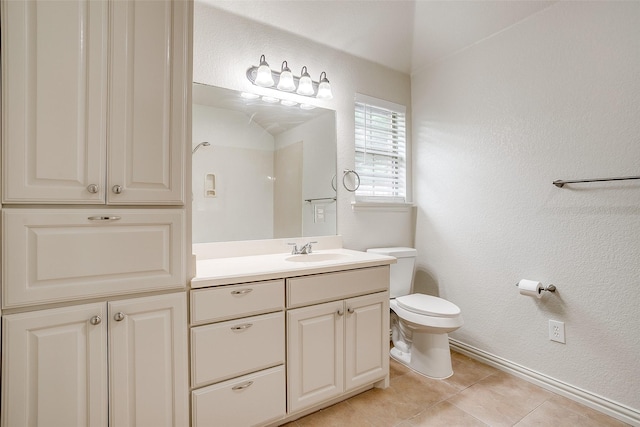 full bath with a textured wall, vanity, toilet, tile patterned floors, and baseboards