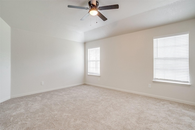 unfurnished room with baseboards, light carpet, and a ceiling fan