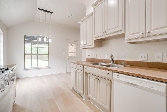 kitchen with a sink, white appliances, light countertops, light wood-type flooring, and pendant lighting