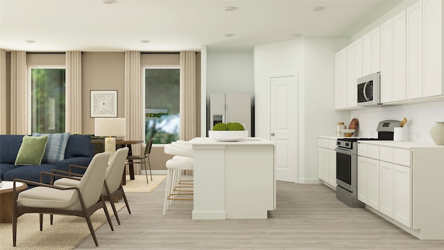kitchen featuring a kitchen island, stainless steel stove, fridge with ice dispenser, light wood finished floors, and backsplash