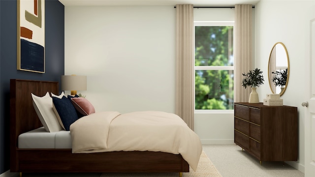 bedroom with light colored carpet and baseboards