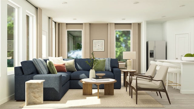 living area with baseboards and light wood-style flooring