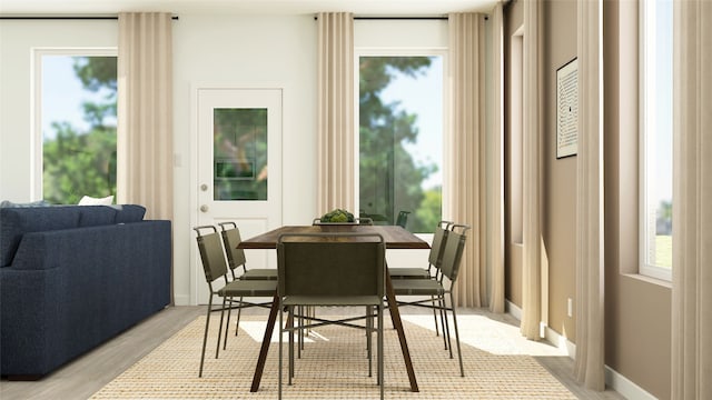dining room with a healthy amount of sunlight and light wood-type flooring