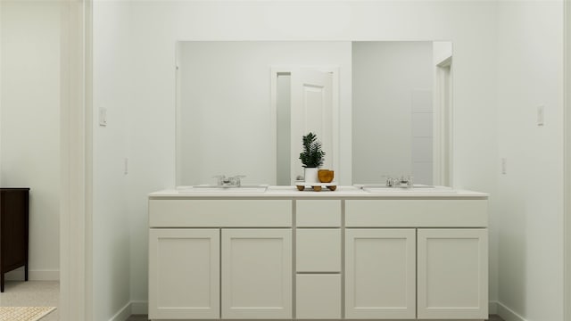 bathroom with double vanity, a sink, and baseboards