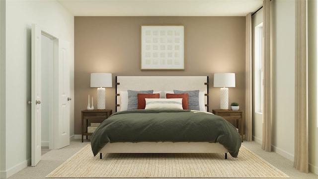 bedroom featuring baseboards and light colored carpet