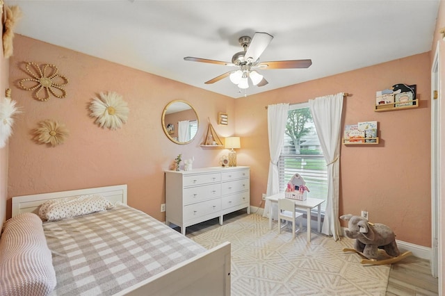 bedroom featuring a ceiling fan and baseboards