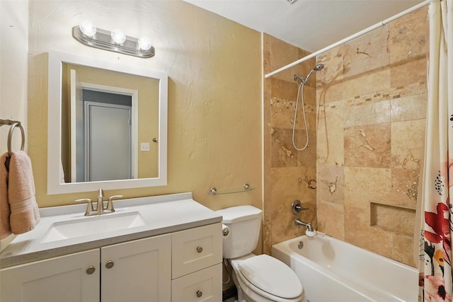 bathroom with vanity, a textured wall, shower / bath combo with shower curtain, and toilet