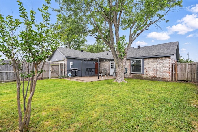 rear view of house featuring brick siding, a patio, and a fenced backyard