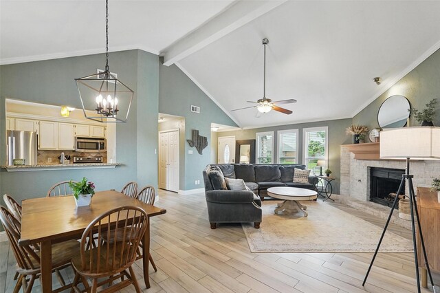 living area with a fireplace, beam ceiling, baseboards, ceiling fan with notable chandelier, and light wood finished floors