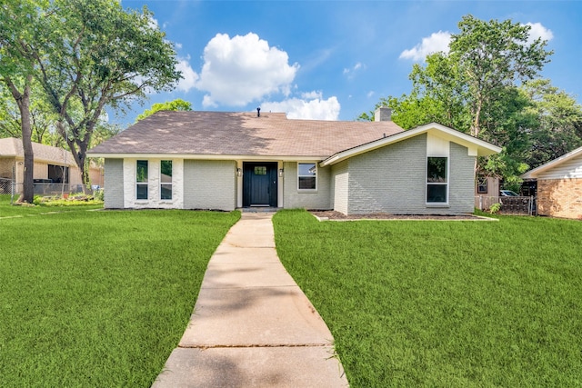 2223 Foxcroft Cir, Denton, TX 76209 - view of front of property featuring brick siding, a shingled roof, fence, and a front yard