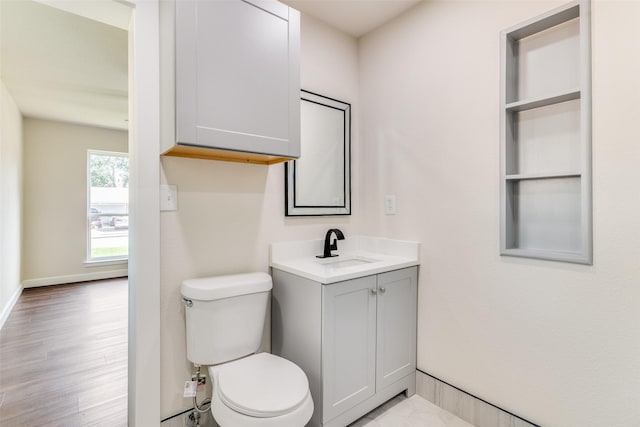 2223 Foxcroft Cir, Denton, TX 76209 - bathroom featuring toilet, baseboards, wood finished floors, and vanity