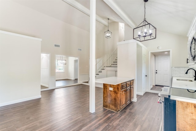 2223 Foxcroft Cir, Denton, TX 76209 - kitchen with a sink, high vaulted ceiling, brown cabinets, and a notable chandelier