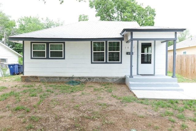 ranch-style home with fence