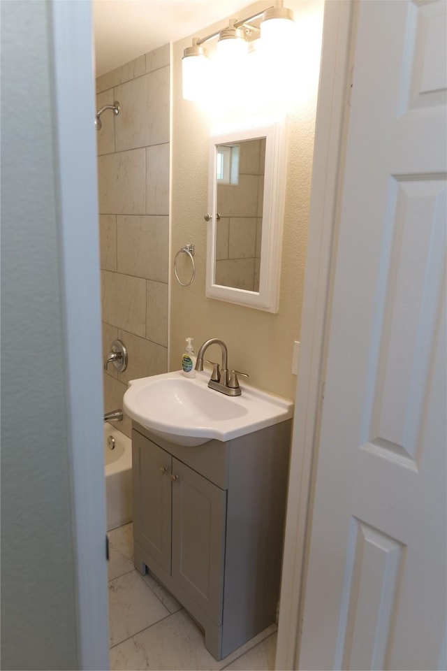 full bath with vanity, shower / bathtub combination, and marble finish floor