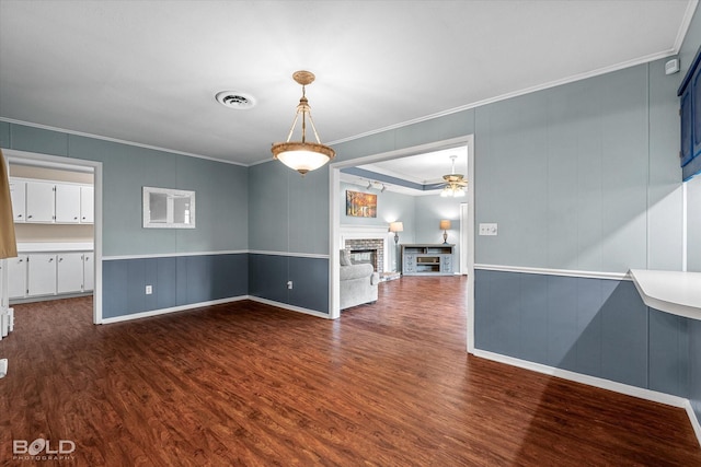 230 Peyton Colquitt Pl, Shreveport, LA 71115 - unfurnished dining area with dark wood-style flooring, ceiling fan, a decorative wall, visible vents, and ornamental molding
