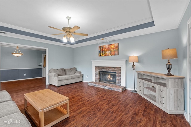 230 Peyton Colquitt Pl, Shreveport, LA 71115 - living area featuring a ceiling fan, a brick fireplace, wood finished floors, a raised ceiling, and ornamental molding