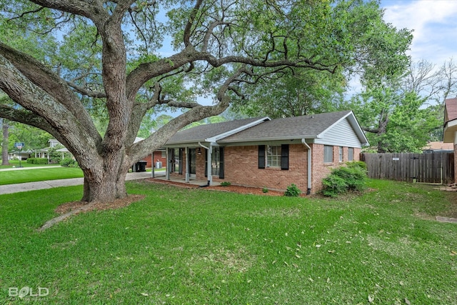 230 Peyton Colquitt Pl, Shreveport, LA 71115 - ranch-style home featuring fence, roof with shingles, brick siding, a front yard, and covered porch
