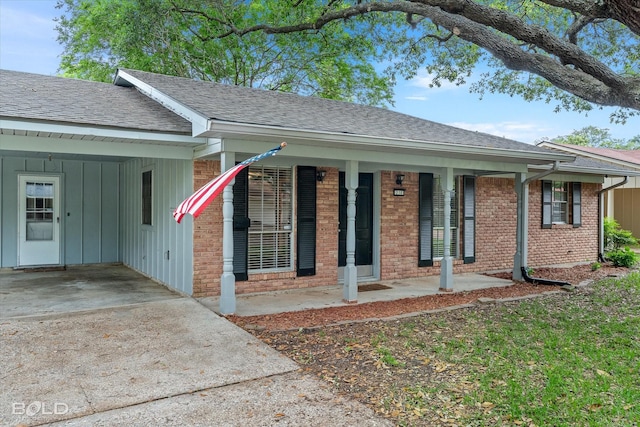 230 Peyton Colquitt Pl, Shreveport, LA 71115 - ranch-style house with roof with shingles, brick siding, a porch, driveway, and a carport