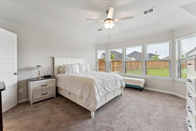 bedroom with visible vents, carpet flooring, and multiple windows