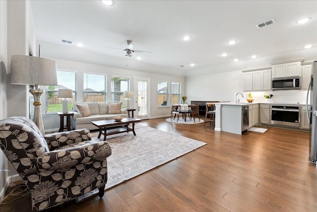 living room featuring visible vents, recessed lighting, ceiling fan, and wood finished floors
