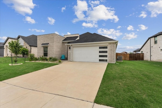 view of front of home with fence, a garage, a front yard, and brick siding