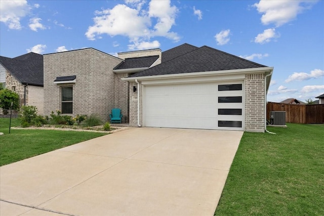 view of front of house featuring fence, cooling unit, a front yard, and brick siding