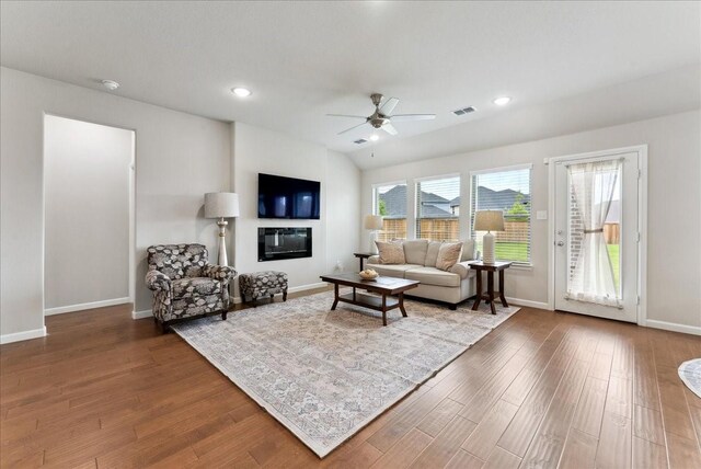 living area featuring ceiling fan, visible vents, baseboards, and wood finished floors