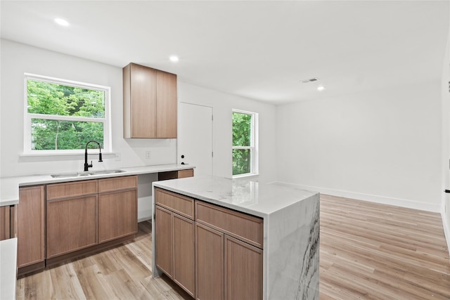 7734 Bruton Rd, Dallas, TX 75217 - kitchen with a sink, light wood finished floors, a center island, recessed lighting, and visible vents