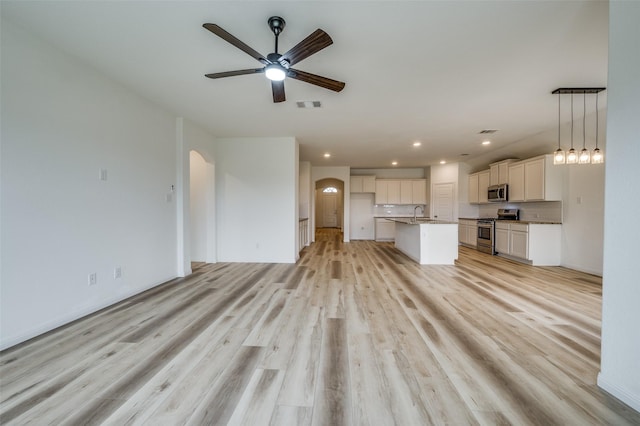 unfurnished living room with ceiling fan, visible vents, baseboards, light wood finished floors, and recessed lighting