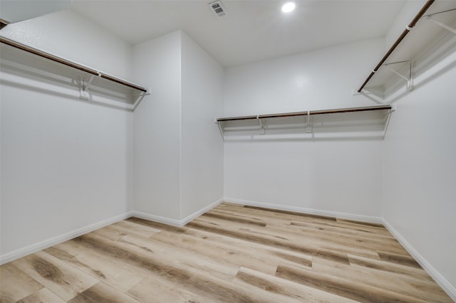 spacious closet featuring visible vents and wood finished floors