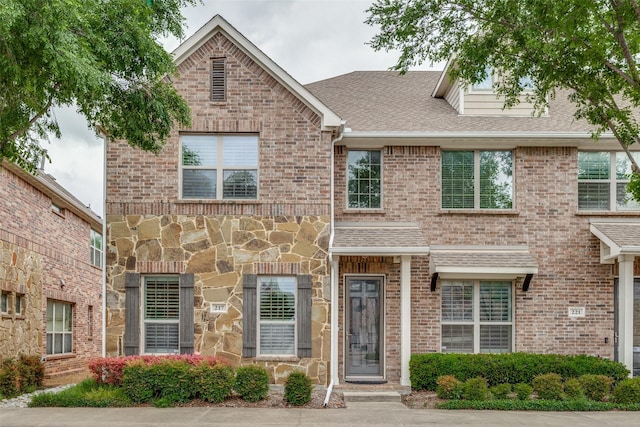 217 Brick Row Dr, Richardson, TX 75081 - view of front of house with brick siding, roof with shingles, and stone siding