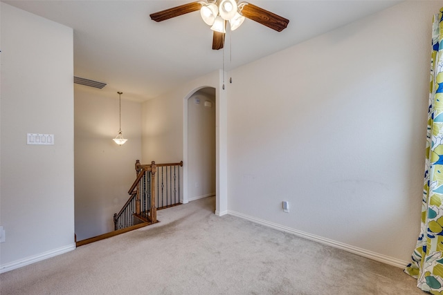 217 Brick Row Dr, Richardson, TX 75081 - carpeted empty room featuring arched walkways, ceiling fan, baseboards, and visible vents
