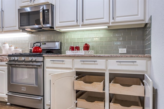 217 Brick Row Dr, Richardson, TX 75081 - kitchen featuring white cabinetry, tasteful backsplash, and stainless steel appliances