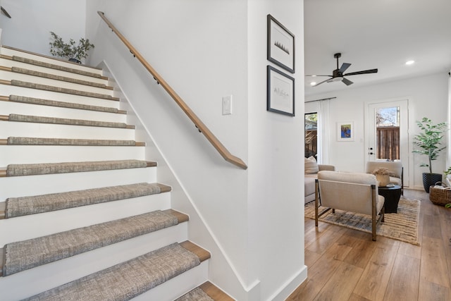 staircase with baseboards, ceiling fan, recessed lighting, and wood finished floors
