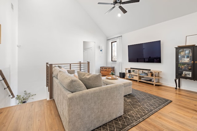 living area with visible vents, a ceiling fan, high vaulted ceiling, and hardwood / wood-style flooring