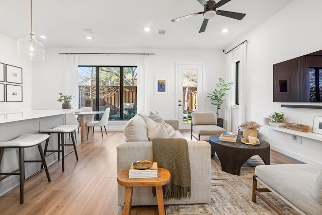 living area featuring recessed lighting, light wood finished floors, ceiling fan, and visible vents