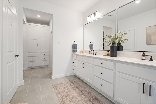 full bathroom with double vanity, tile patterned floors, recessed lighting, and a sink