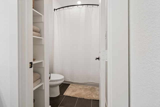 full bath with toilet, curtained shower, and tile patterned flooring
